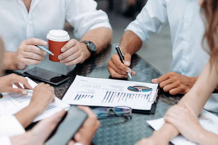 businessman using a smartphone during an office meeting.の写真素材