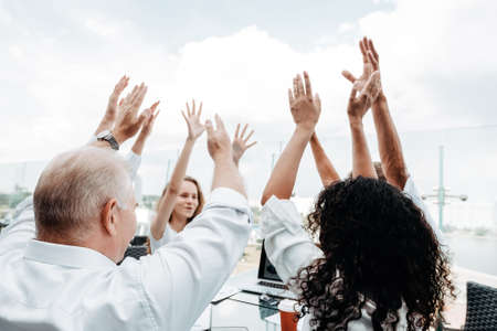happy business team showing their success with a hand up.の写真素材