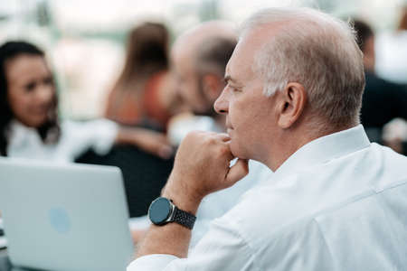 mature successful businessman sitting at his desk.の写真素材