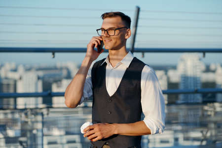 young entrepreneur talking on his smartphone. close-up.の写真素材