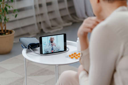 sick woman using a digital tablet for medical advice .の写真素材