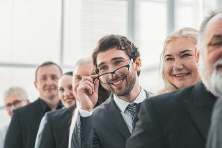 close up. smiling businessman standing in a row with his colleagues