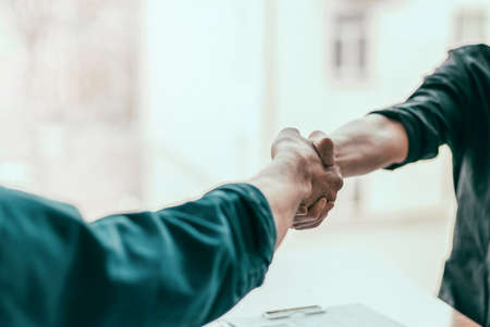 close up. financial partners are shaking hands with each other .の写真素材