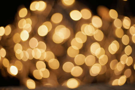 blurred golden lights on a black background .