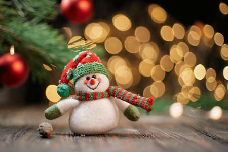 funny toy snowman on the background of Christmas lights.の写真素材