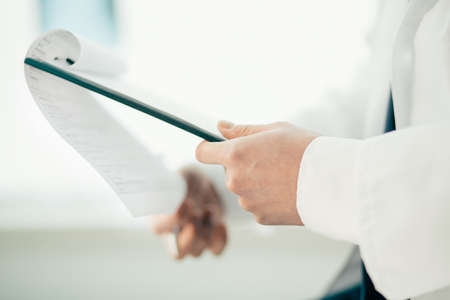 close-up. doctor filling out a medical form.