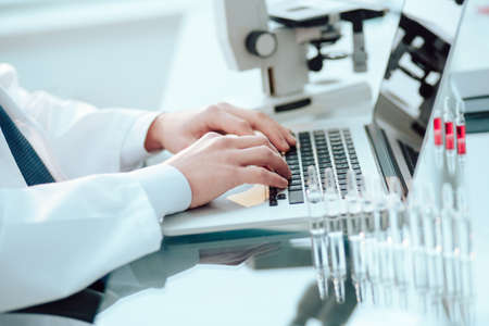 scientist works on a laptop in a medical laboratory.の写真素材