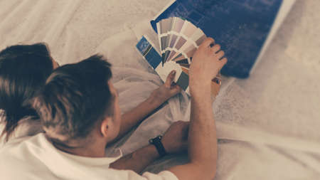 young couple discussing the new design of their apartment.の写真素材