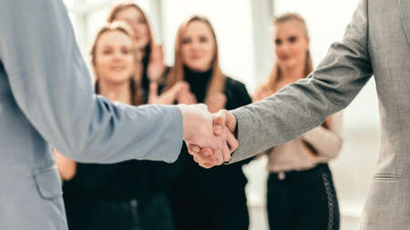 young business people shaking hands with each other.
