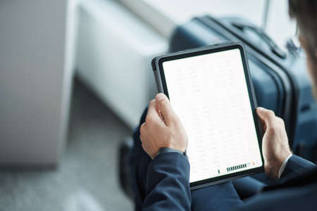 digital tablet in the hands of an airport passenger.の写真素材