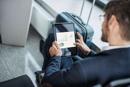 businessman using a digital tablet during a business trip.の写真素材