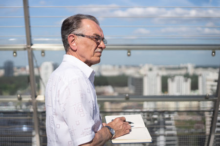businessman with a notebook standing on the terrace of the business center .の写真素材