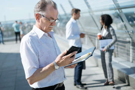 businessman reading e-mail standing on the terrace of the business center .