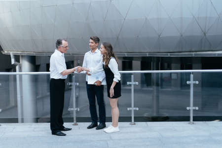business colleagues greeting each other in the corridor of the business center.