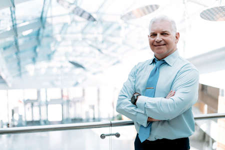 satisfied businessman standing on the balcony of a business center .の写真素材