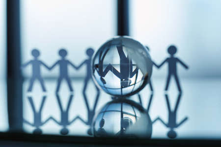 glass globe and a paper business team on an office background .の写真素材