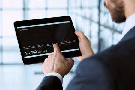 business man using a digital tablet to work with cryptocurrency.の写真素材