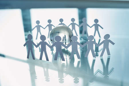 paper business team standing around a glass globe .の写真素材