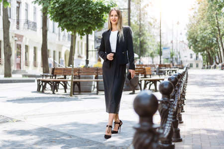 young businesswoman standing on a city street .の写真素材