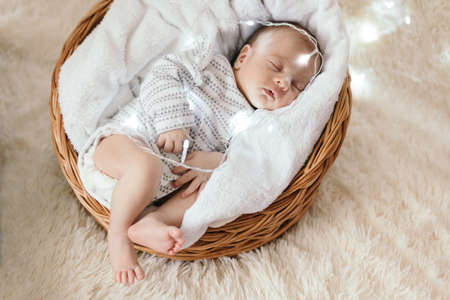 newborn baby is fast asleep in a baby basket.の写真素材