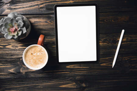 tablet pc,stylus and coffee cup on a wooden background.の写真素材