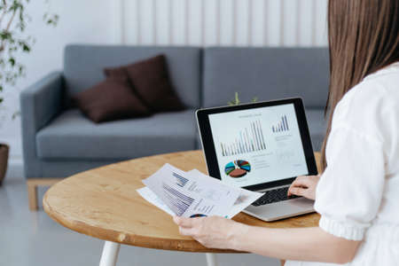 woman checking financial documents in her home office.