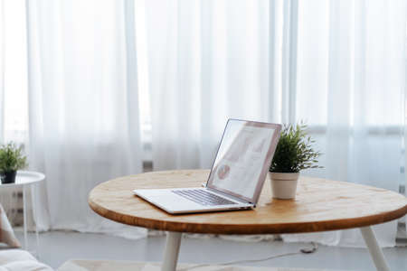 open laptop on the table in the cozy living room.