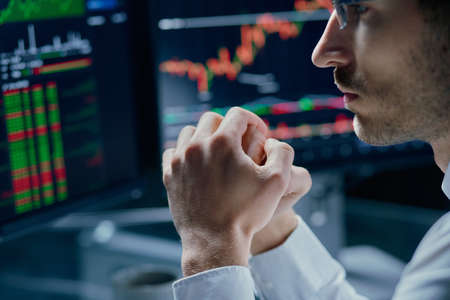 crypto trader reflecting on the risks of investing fundsの写真素材