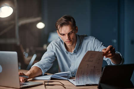 businessman using a laptop to work with documents .