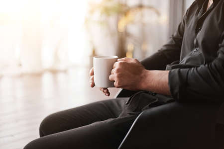 cropped image of a businessman with a cup of coffee.の写真素材