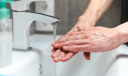 close-up. person carefully soaping the palms of his hands .の写真素材