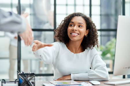 businesswoman holding out her hand for a handshake .の写真素材