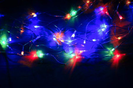 garland with colorful lights on black background