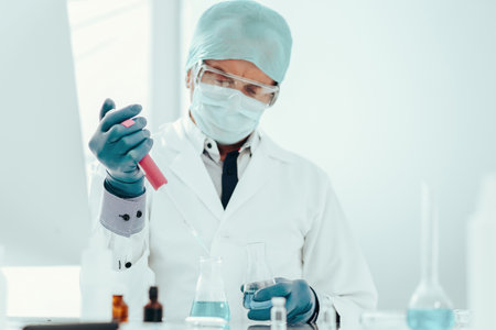 ampoule with a vaccine in the hands of a female scientist.の写真素材