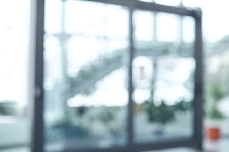 blurry image of glass sliding doors in an office building .の写真素材