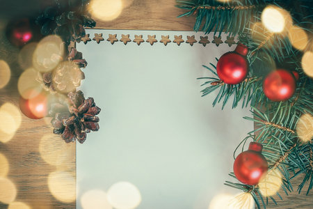 blank Christmas card and ornaments on wooden background.の写真素材