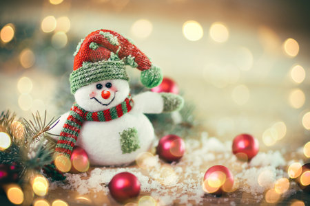 Christmas card. toy snowman on a festive background.の写真素材