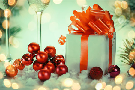 two glasses with champagne, and boxes with gifts on Christmas baの写真素材
