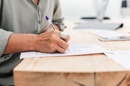 close up. business woman writing while sitting at the tableの写真素材
