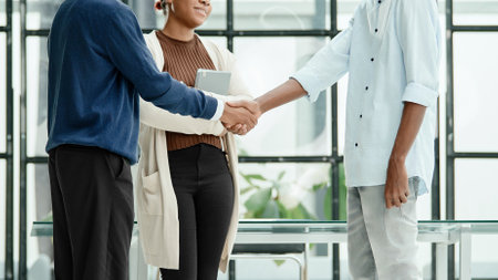 young business people greeting each other with a handshakeの写真素材