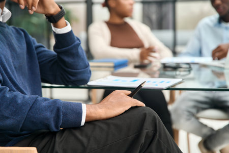businessman sitting near the desktop with financial documents.の写真素材