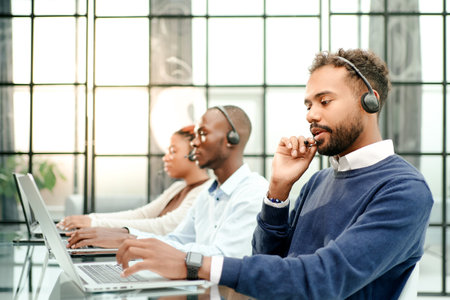 call center operator in headset working in office.の写真素材