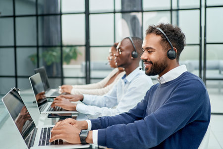 call center operator in headset working in office.の写真素材