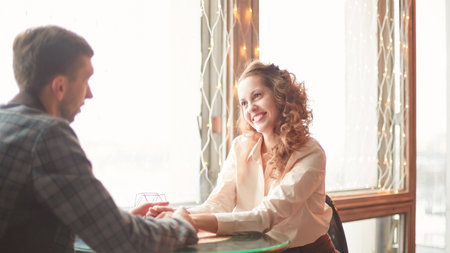 close up. loving couple sitting at a table in a cozy cafeの写真素材