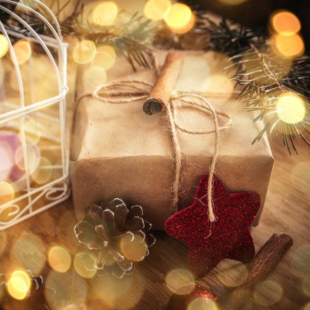 .box with gift on Christmas background . retro style. beautiful bokeh effect from a garland.の写真素材