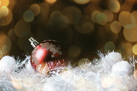 beautiful red Christmas ball on a black background. beautiful bokeh effect from a garland.の写真素材