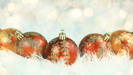 Christmas. red glass balls with ornaments on a white background. beautiful bokeh effect from a garland.の写真素材