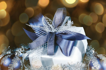 closeup .Christmas gift and blue Christmas balls on a festive black background. beautiful bokeh effect from a garland.の写真素材