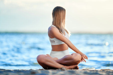 athletic young woman sitting in yoga poseの写真素材