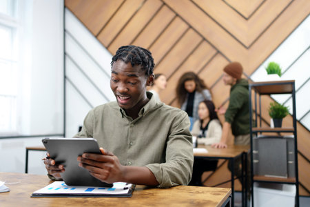 young entrepreneur with a digital tablet works in a coworking center.の写真素材